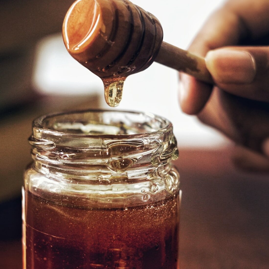 A jar of Chico raw honey with a dipper